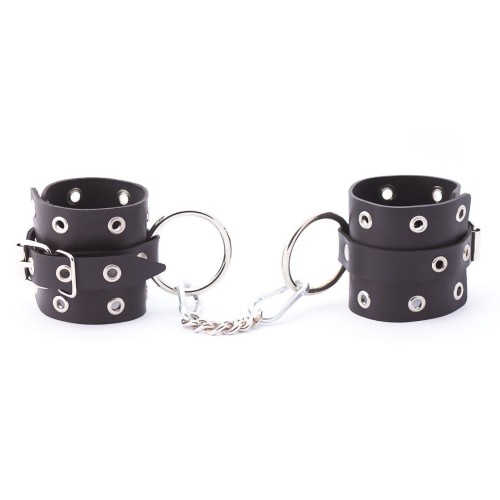 Черные кожаные наручники с люверсами