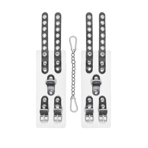 Бело-черные наручники с двумя ремешками и люверсами